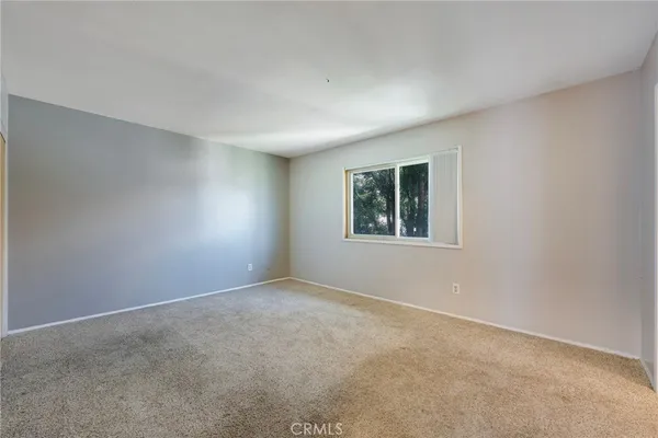 a bedroom with a bed and a potted plant