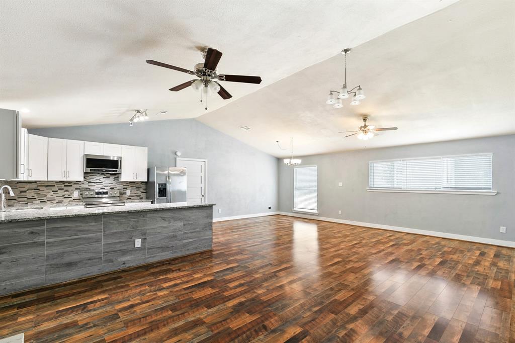 909 North Dove Road Grapevine, TX 76051 - Photo 12 of 30 Vaulted ceiling with wood-finish flooring
