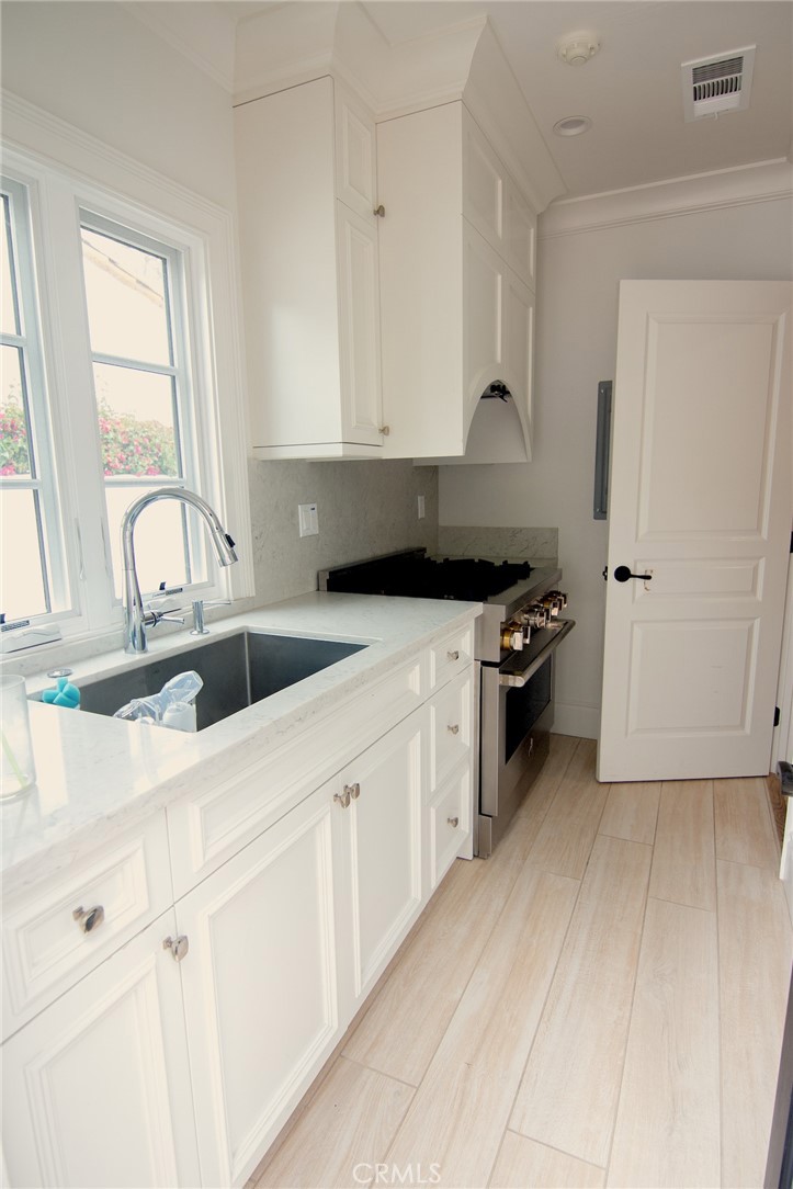 2159 Lorain Road San Marino, CA 91108 - Photo 19 of 48 a kitchen with stainless steel appliances a sink a stove and a refrigerator