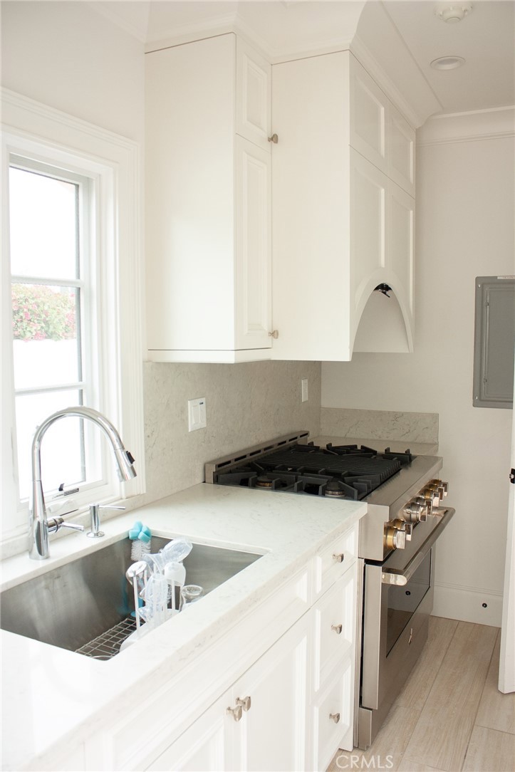 2159 Lorain Road San Marino, CA 91108 - Photo 20 of 48 a kitchen with granite countertop a sink a stove and a window