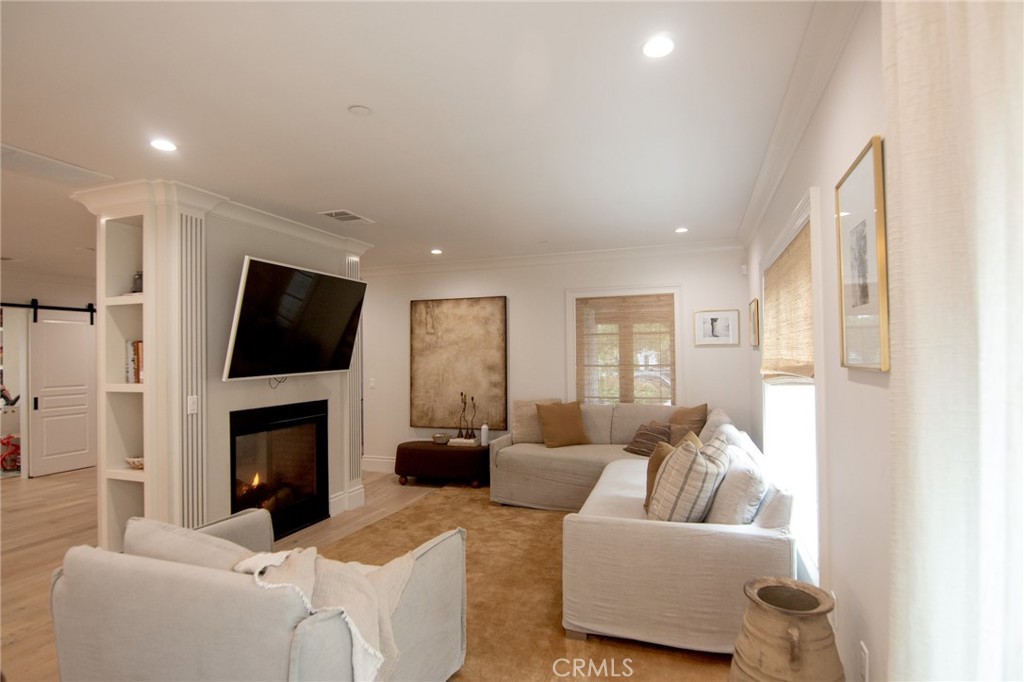 2159 Lorain Road San Marino, CA 91108 - Photo 8 of 48 a living room with furniture a flat screen tv and a fireplace