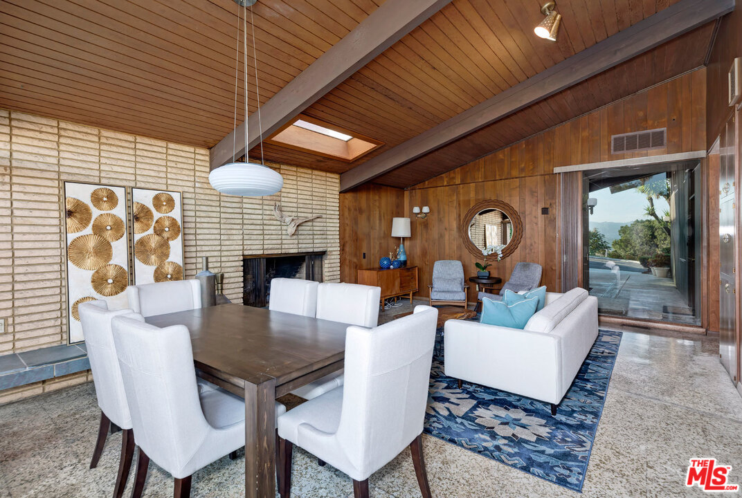 5961 Wrightcrest Drive Culver City, CA 90232 - Photo 15 of 41 a dining room with furniture a rug and a large window