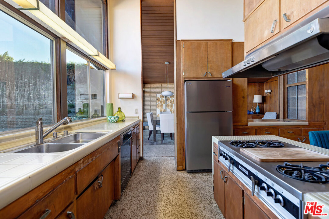 5961 Wrightcrest Drive Culver City, CA 90232 - Photo 17 of 41 a kitchen with stainless steel appliances granite countertop a refrigerator a sink and a stove