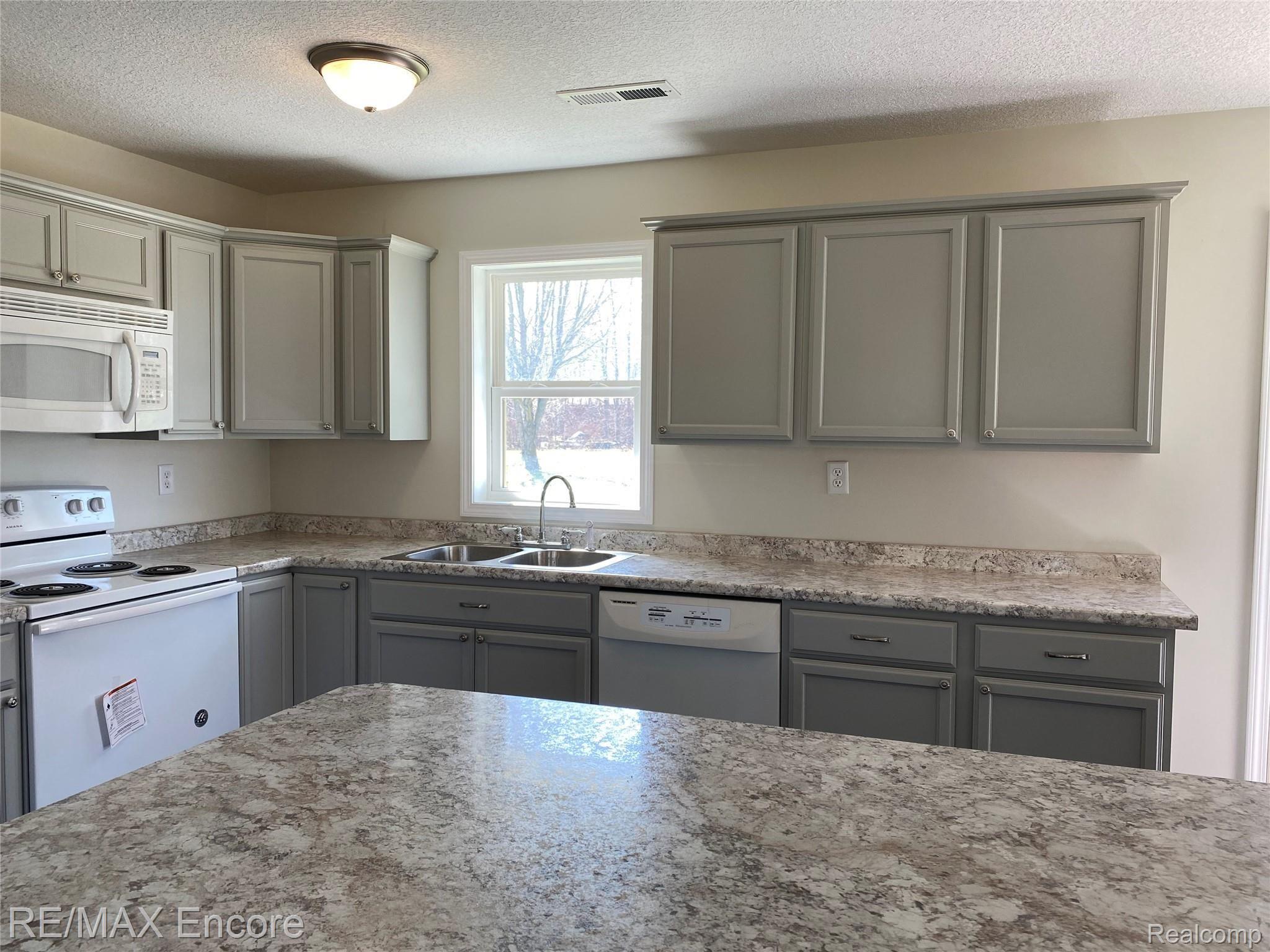 8060 Newburg Road Durand, MI 48429 - Photo 10 of 41 Beautiful kitchen overlooking the backyard. Huge island for entertaining!