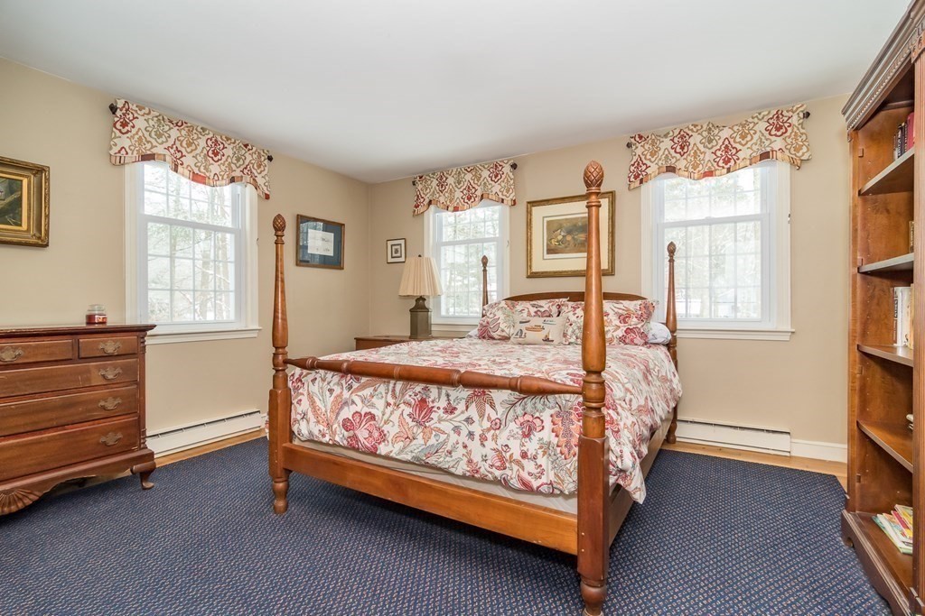 13 Colonial Road Dover, MA 02030 - Photo 12 of 23 a bed sitting in a bedroom next to a window