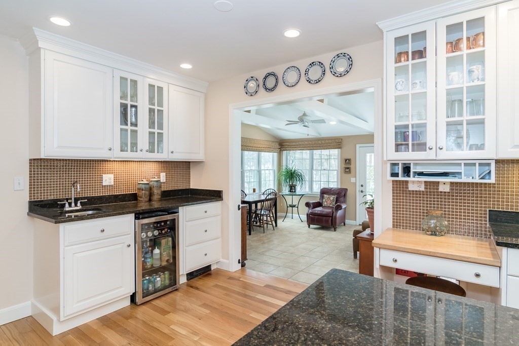 13 Colonial Road Dover, MA 02030 - Photo 7 of 23 a kitchen with granite countertop a stove and a view of living room