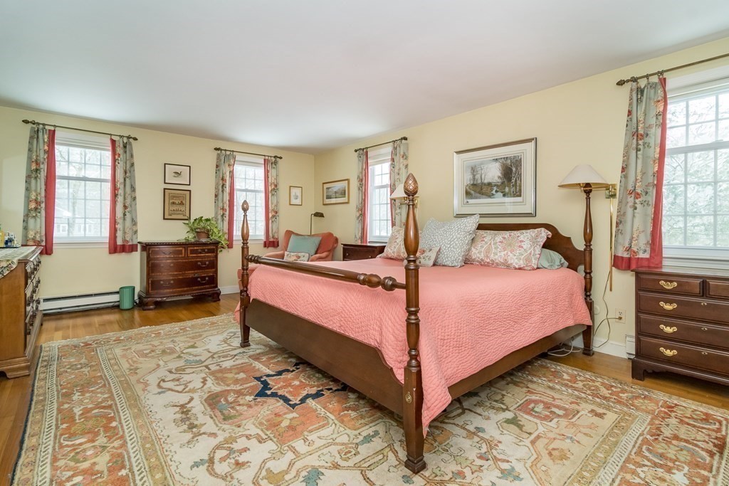 13 Colonial Road Dover, MA 02030 - Photo 10 of 23 a bedroom with a bed and wooden floor