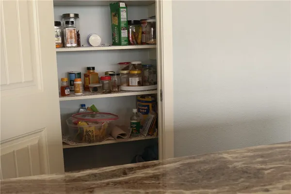 a kitchen with a sink and a stove with wooden floor
