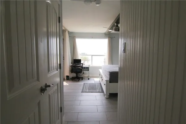 a bedroom with a bed and a chair