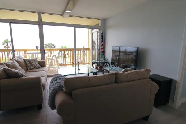 a living room with furniture and a flat screen tv