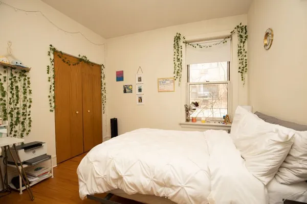 a bedroom with a bed and a window