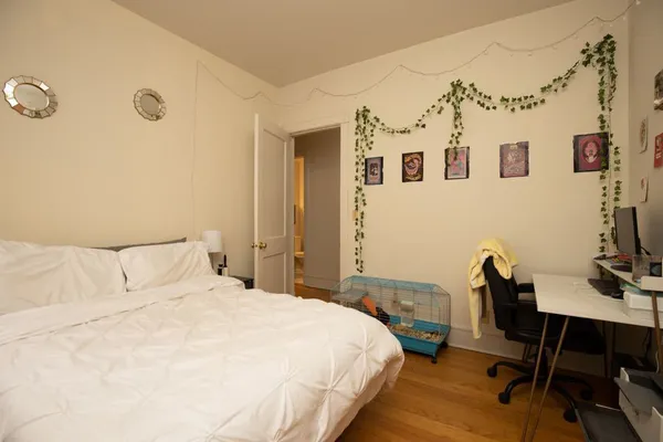 a bedroom with a bed and a desk