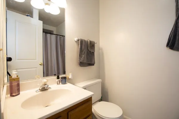 a bathroom with a sink vanity mirror and toilet