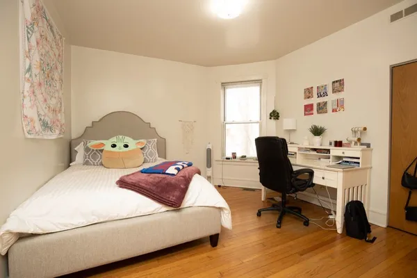 a bedroom with a bed and a workspace