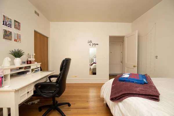 a bedroom with a bed and a chair