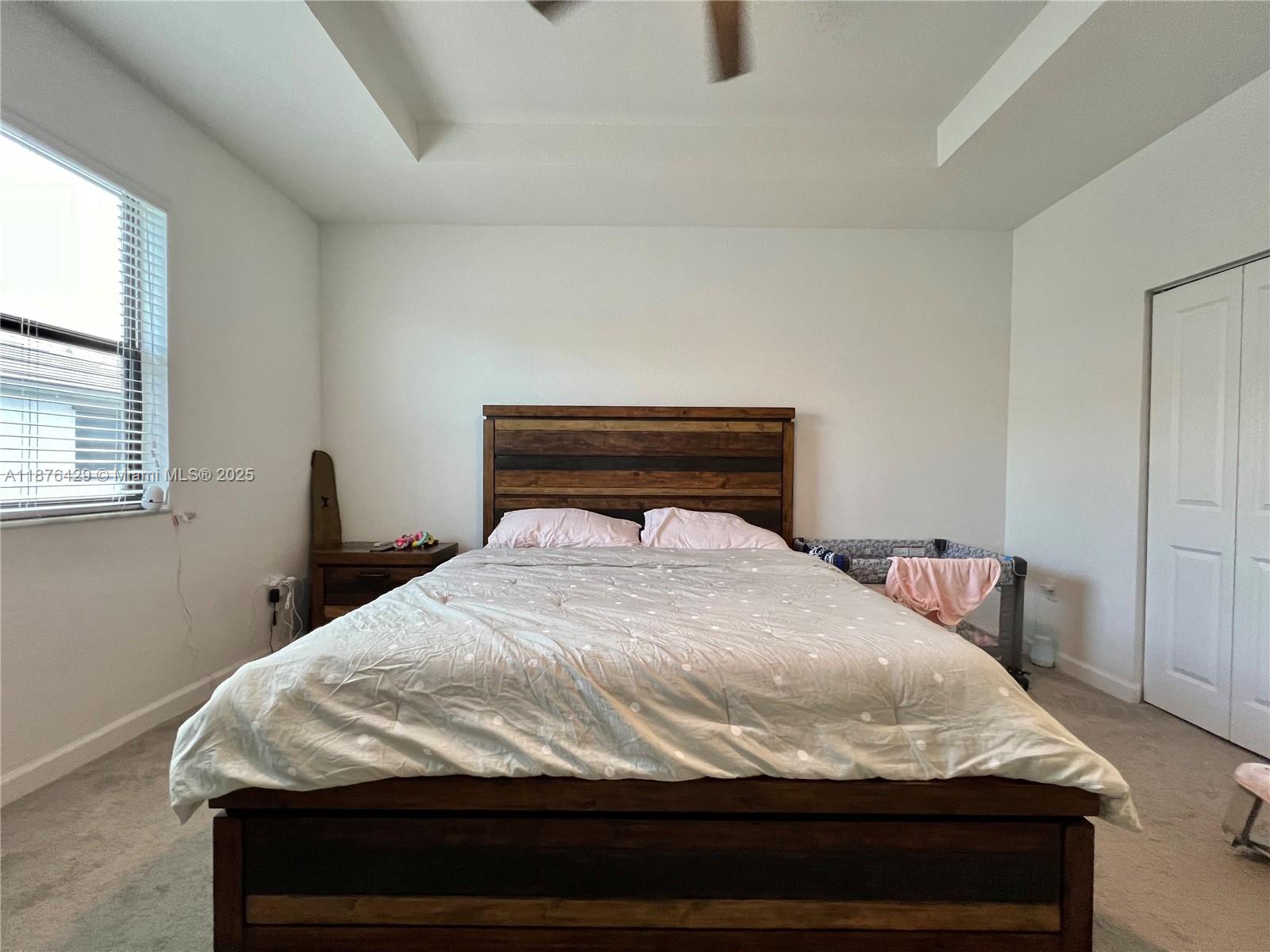 13371 Southwest 287th Street Homestead, FL 33033 - Photo 19 of 37 a bed sitting in a bedroom next to a window