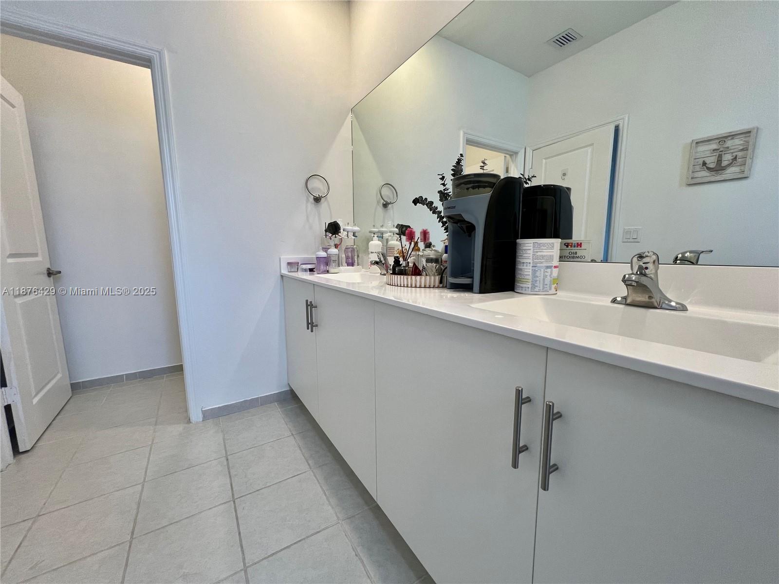 13371 Southwest 287th Street Homestead, FL 33033 - Photo 22 of 37 a bathroom with a sink and a mirror