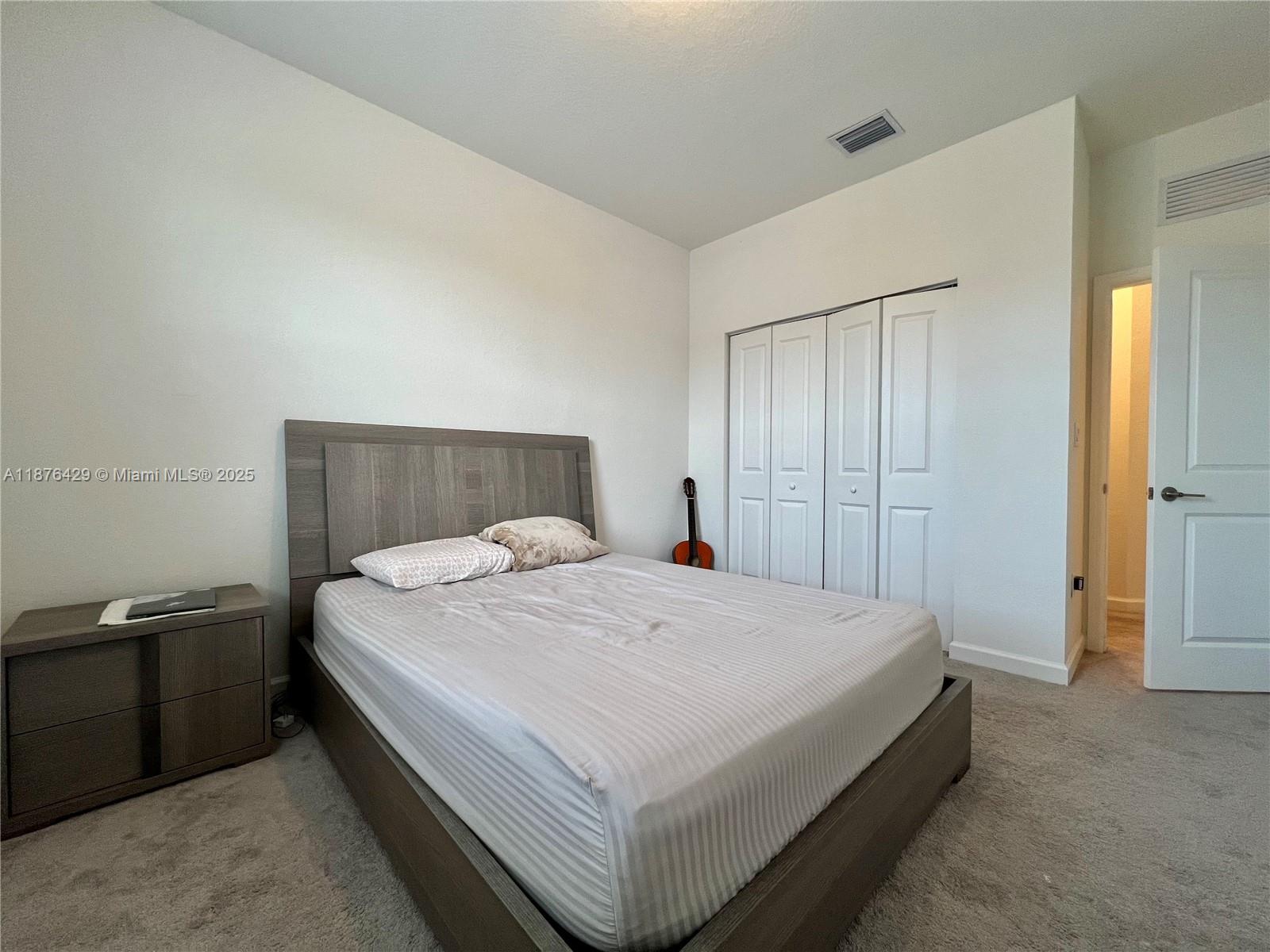 13371 Southwest 287th Street Homestead, FL 33033 - Photo 30 of 37 a bedroom with a bed and a closet