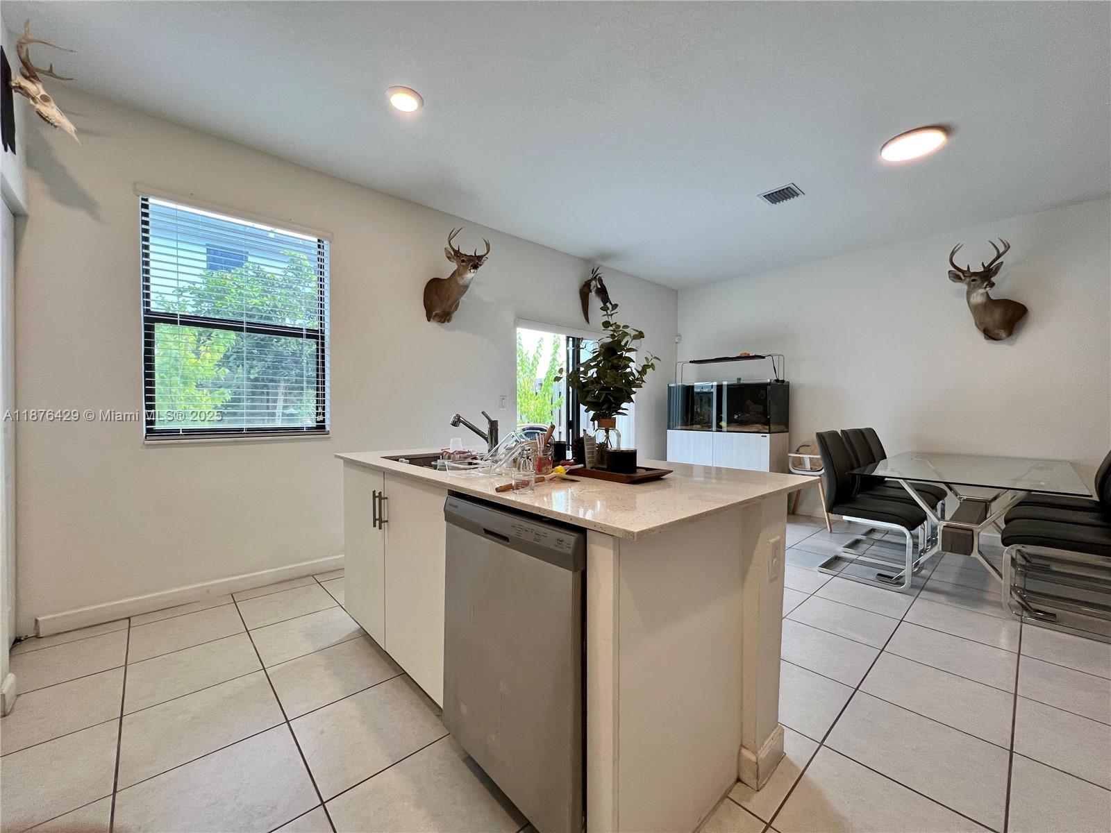 13371 Southwest 287th Street Homestead, FL 33033 - Photo 7 of 37 a kitchen with a sink and cabinets