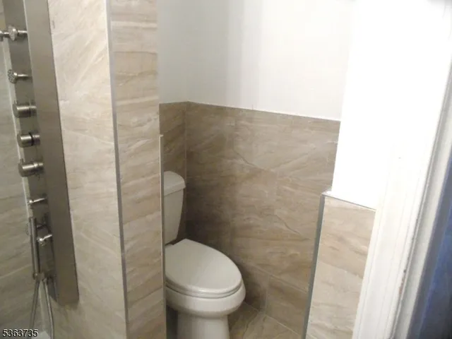 a bathroom with a toilet and a shower