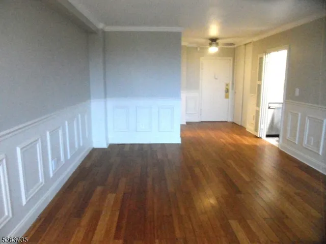 a view of a room with wooden floor