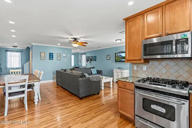 a bathroom with a granite countertop toilet a sink and mirror
