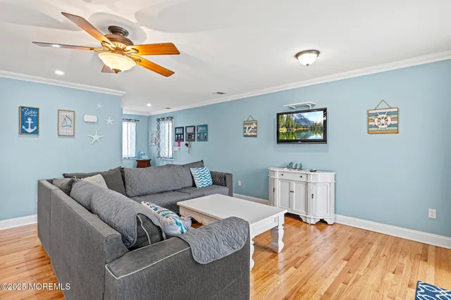 a kitchen with stainless steel appliances granite countertop a refrigerator a stove a sink dishwasher with a dining table and chairs with wooden floor