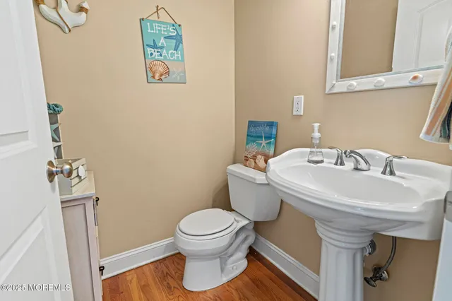 a bathroom with a sink a toilet and mirror