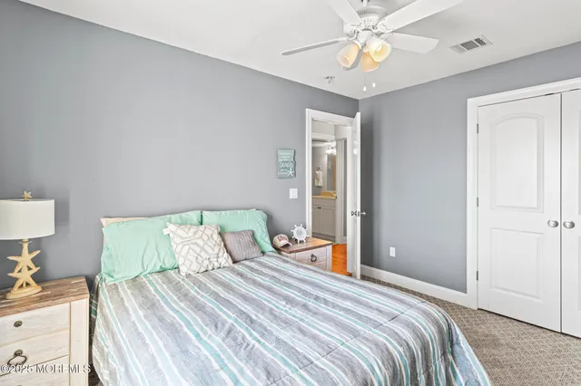 a bedroom with a bed and a flat screen tv on dresser