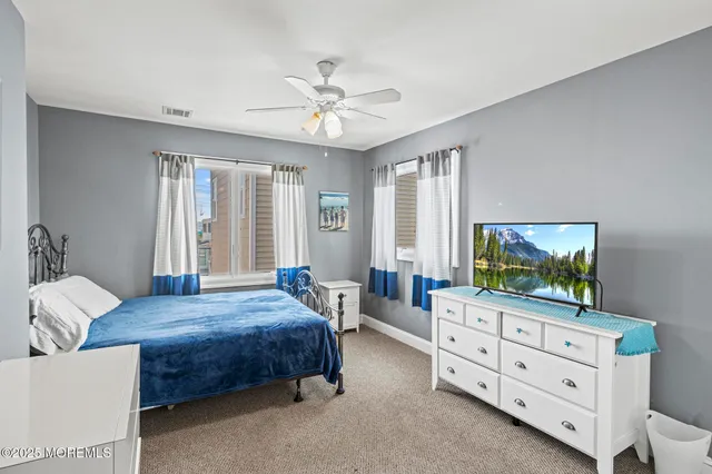 a bedroom with a large bed and a chandelier