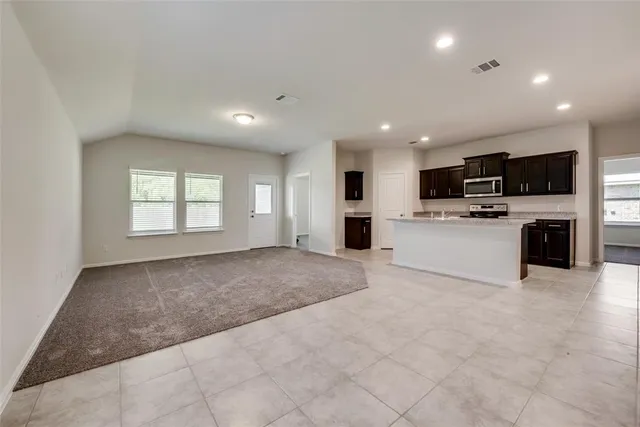 a view of kitchen with stove and microwave