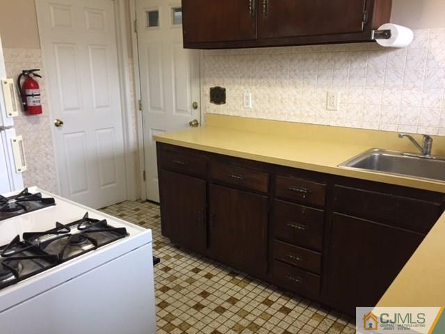 44 Clemson Road Old Bridge, NJ 08859 - Photo 4 of 12 a kitchen with a sink and a stove