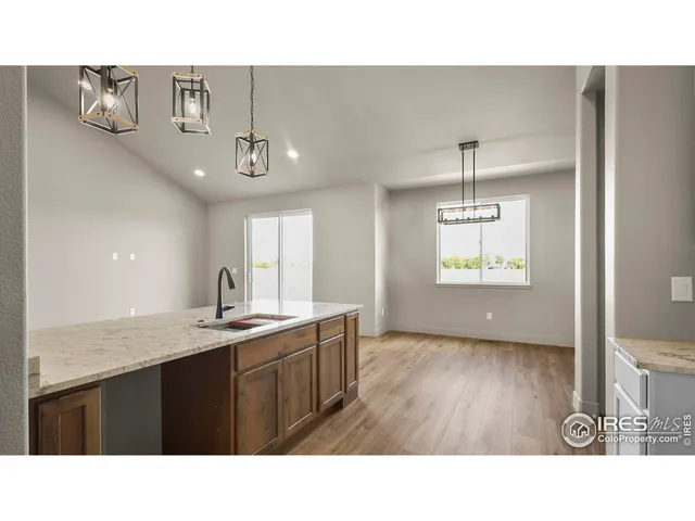 a kitchen with a sink a window and stainless steel appliances