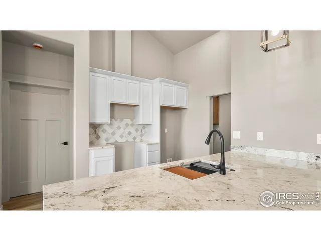 a kitchen with a refrigerator and a sink