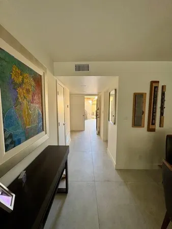a bedroom with a bed and a flat tv screen on the dresser