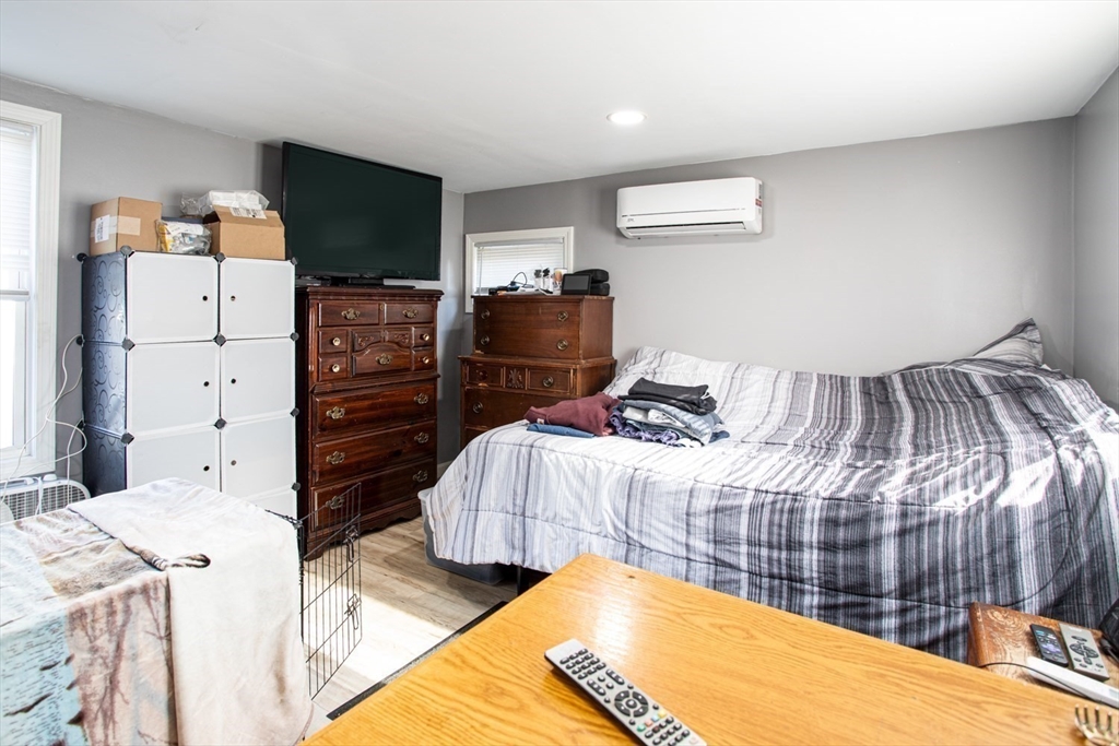 415 Anthony Street Fall River, MA 02721 - Photo 8 of 16 a bedroom with a bed and flat screen tv