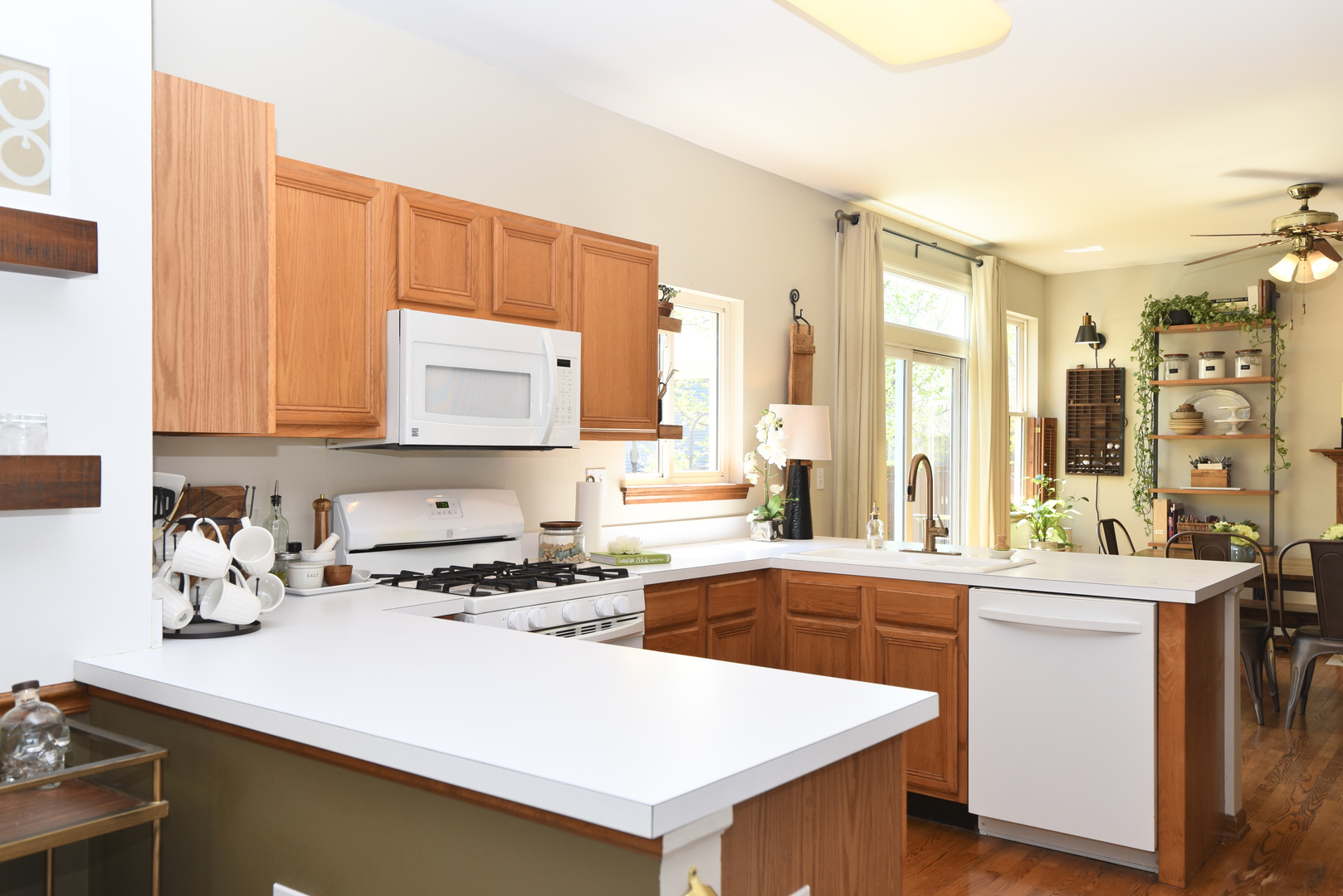 1389 Lily Cache Lane Bolingbrook, IL 60490 - Photo 7 of 45 a kitchen with a sink a stove and white cabinets