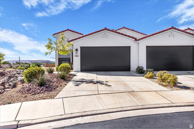 794 North Via Modelo Circle Washington, UT 84780 - Photo 2 of 21 View of front facade featuring stucco siding, a tiled roof, concrete driveway, and a garage