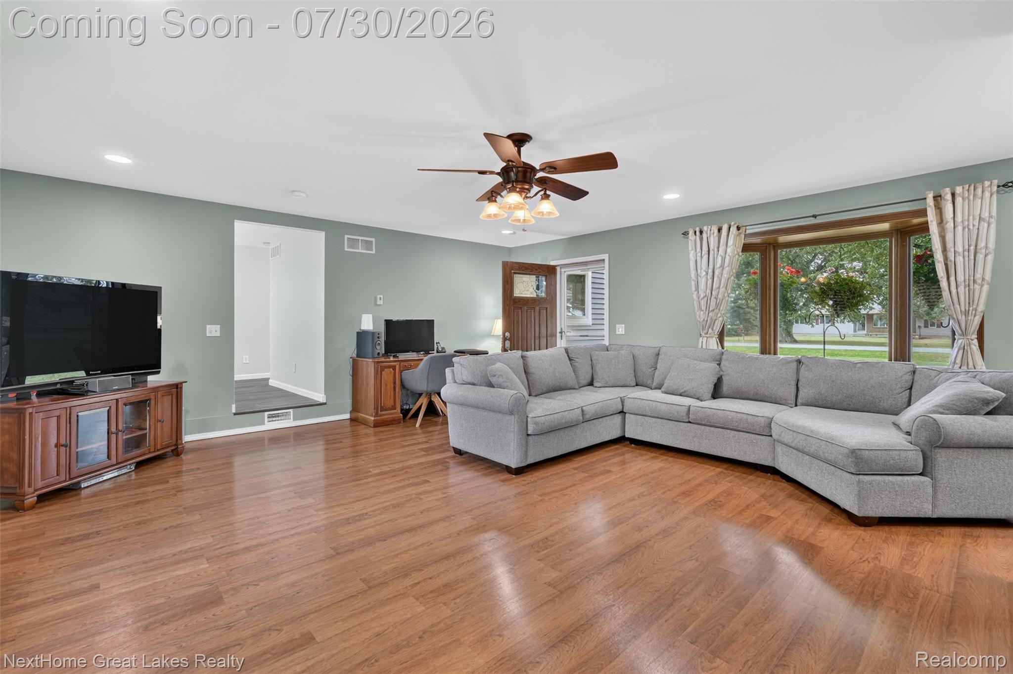 6249 North New Lothrop Road New Lothrop, MI 48460 - Photo 8 of 50 Spacious living area featuring wood-finish flooring, recessed lighting, and a ceiling fan with integrated light fixture