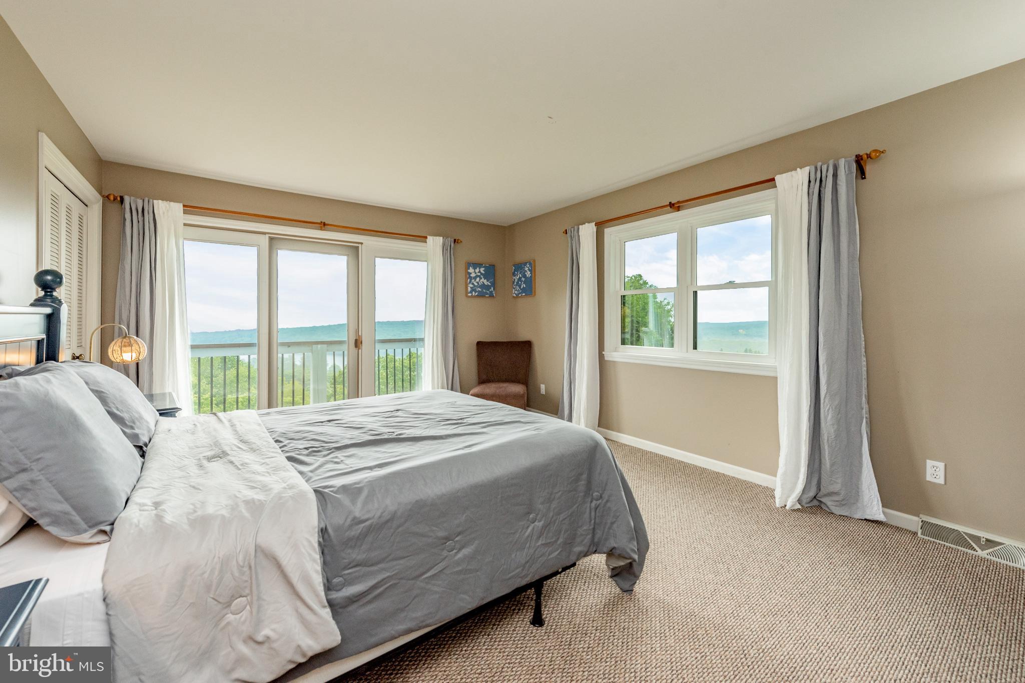 467 Paradise Ridge Road Oakland, MD 21550 - Photo 36 of 64 a bedroom with a large bed and a large window