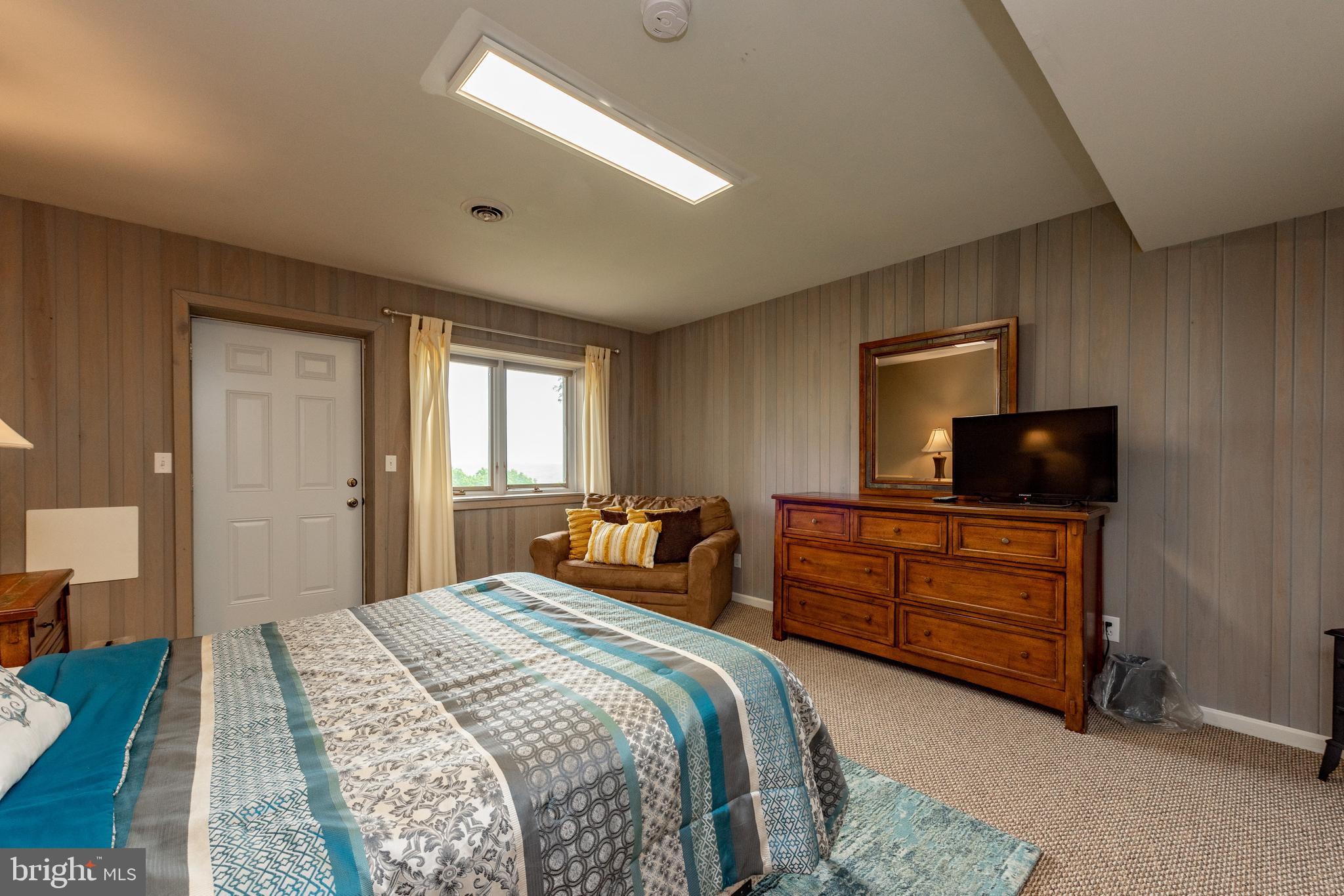 467 Paradise Ridge Road Oakland, MD 21550 - Photo 43 of 64 a bedroom with a bed and flat screen tv