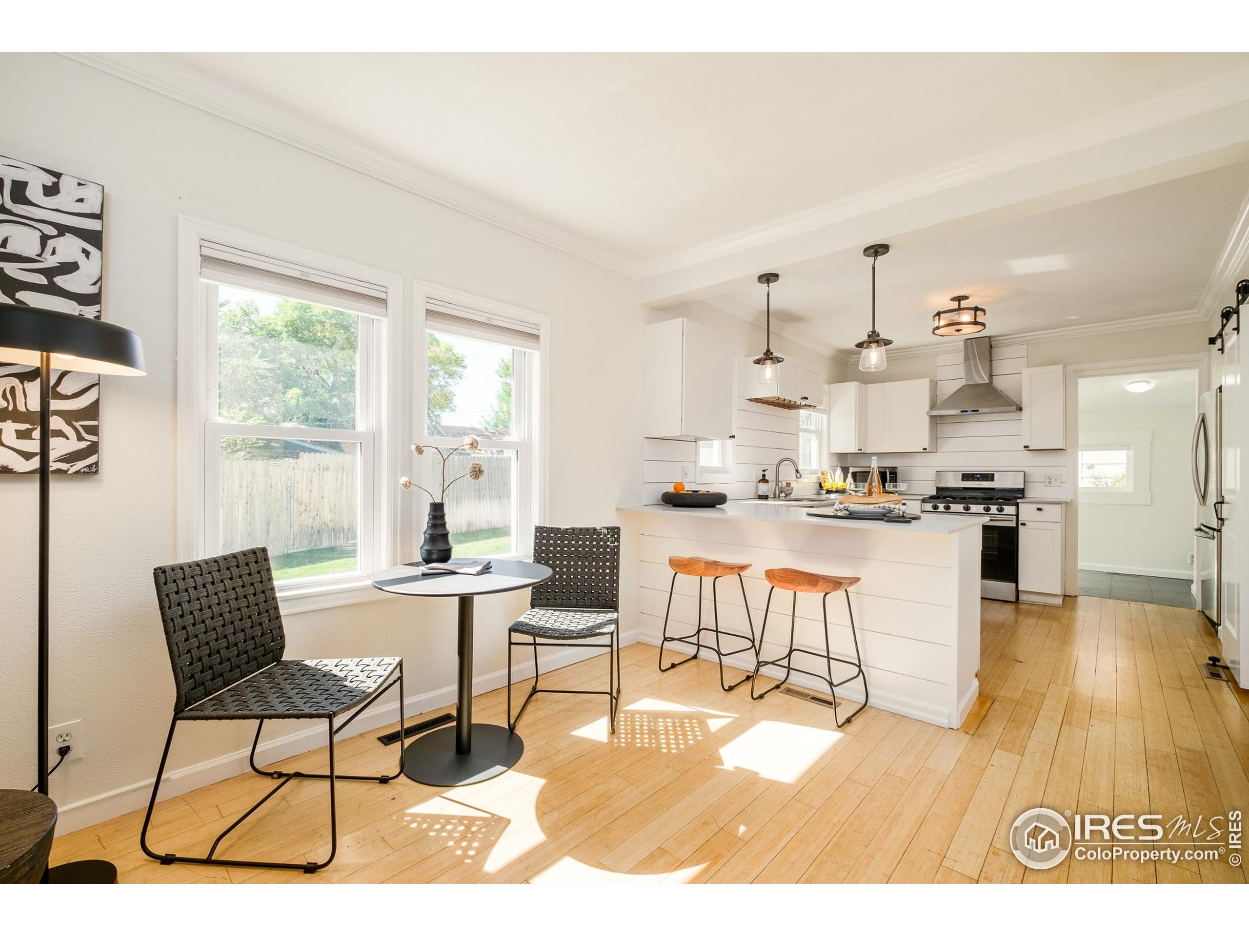 4635 Elm Court Denver, CO 80211 - Photo 1 of 30 a living room with stainless steel appliances kitchen island granite countertop furniture and a large window