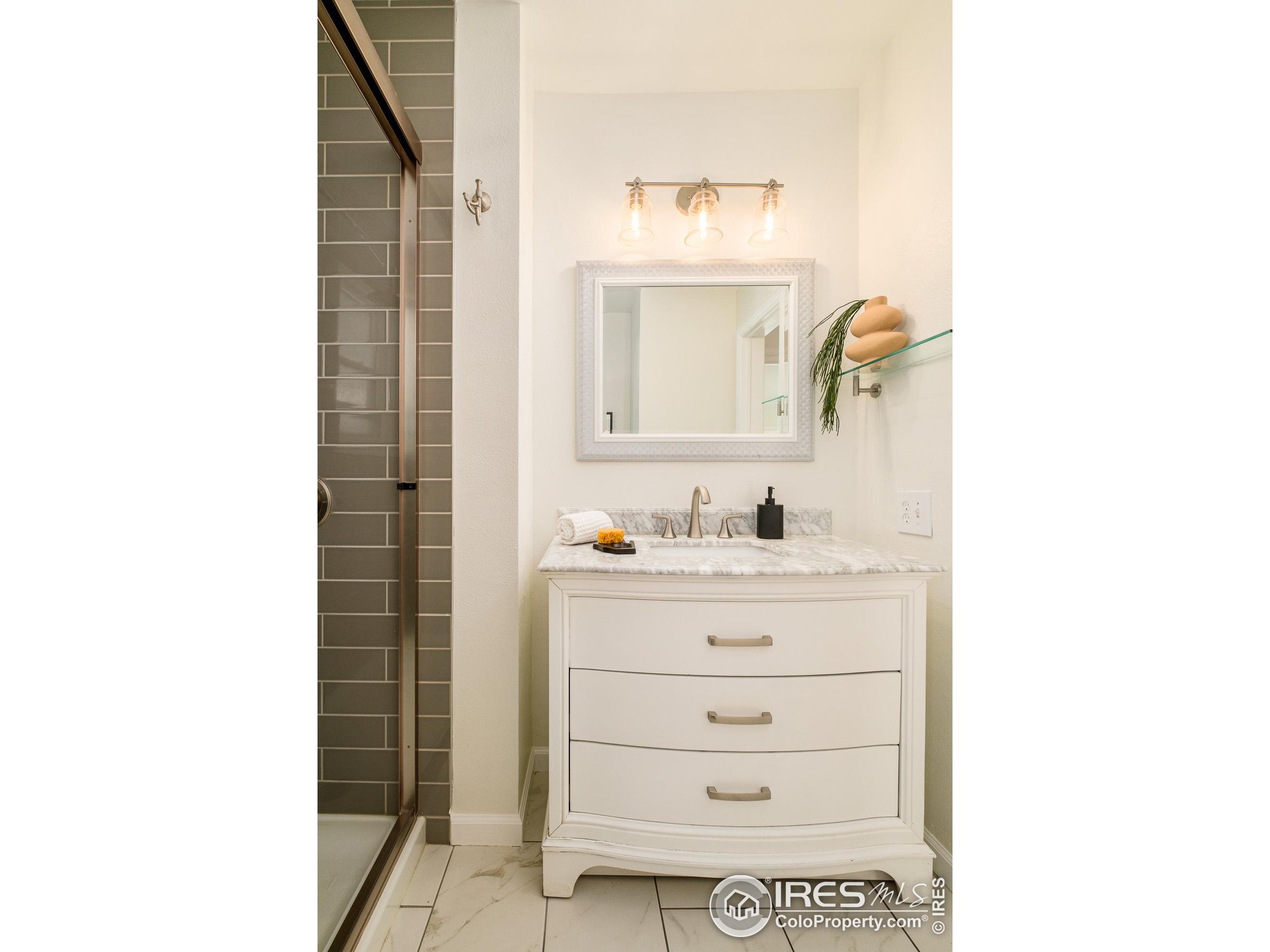 4635 Elm Court Denver, CO 80211 - Photo 17 of 30 a bathroom with a sink and a mirror