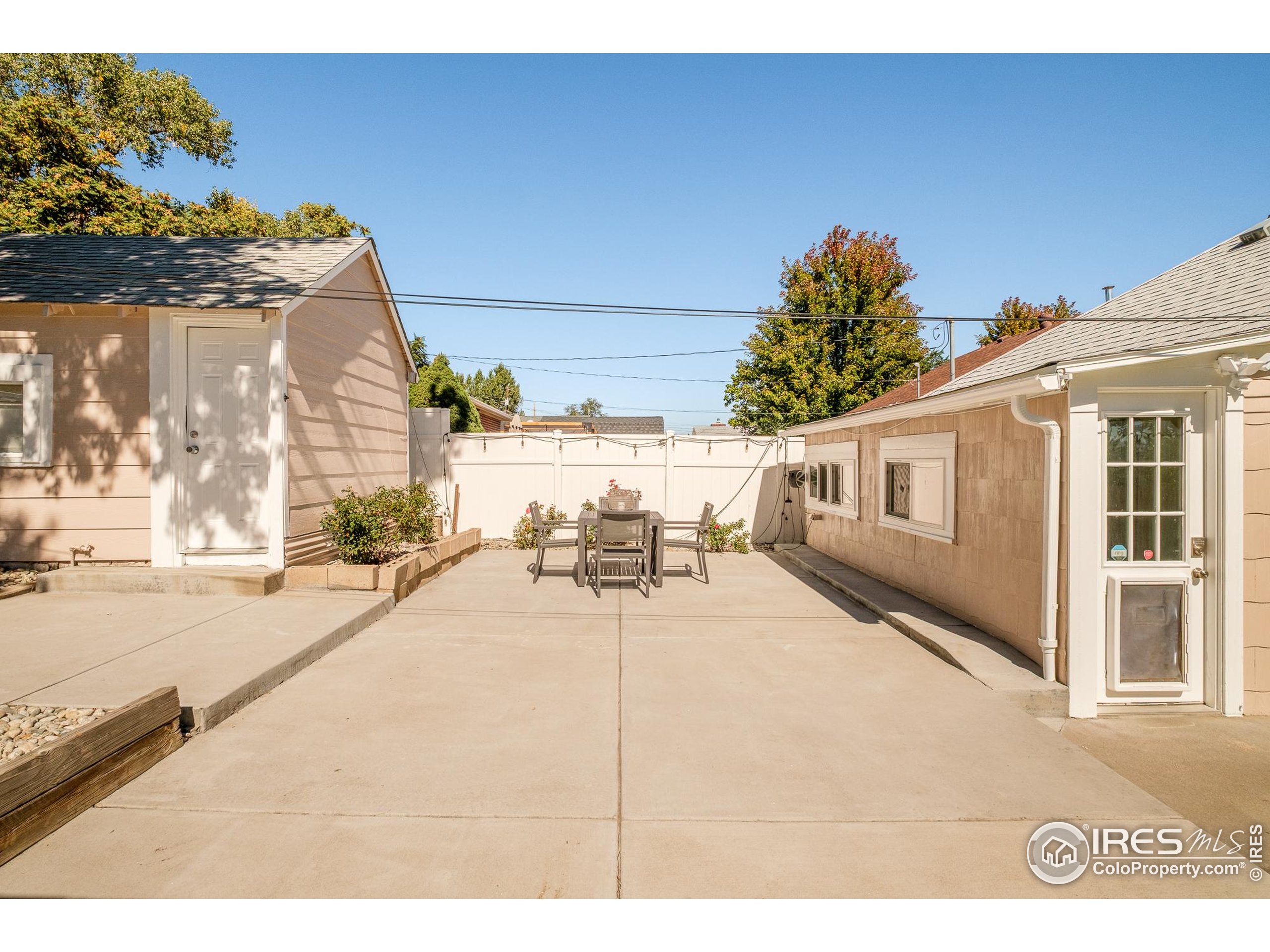 4635 Elm Court Denver, CO 80211 - Photo 26 of 30 a view of a patio with a table and chairs and potted plants