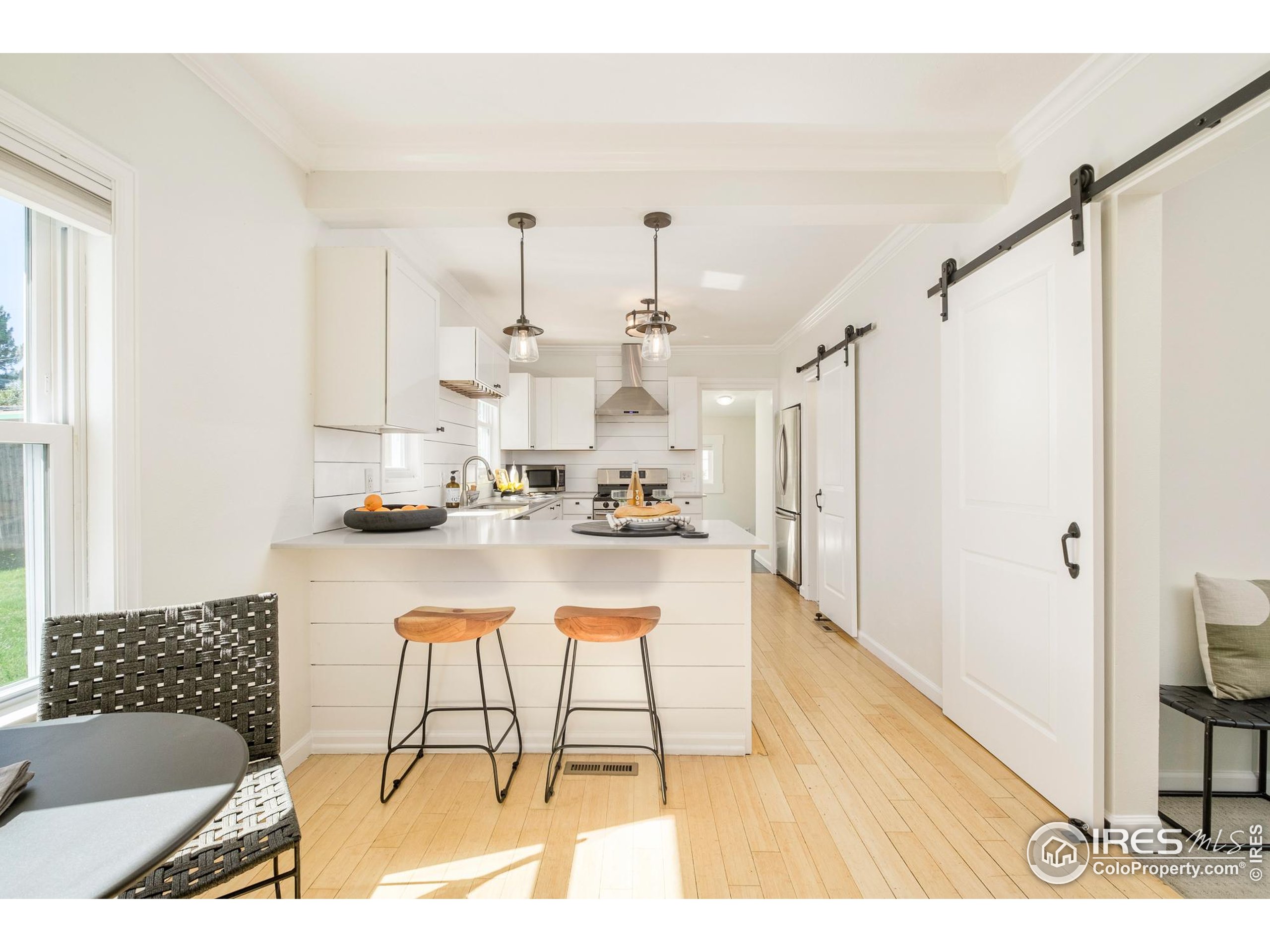 4635 Elm Court Denver, CO 80211 - Photo 5 of 30 a view of open kitchen with dining table and appliances