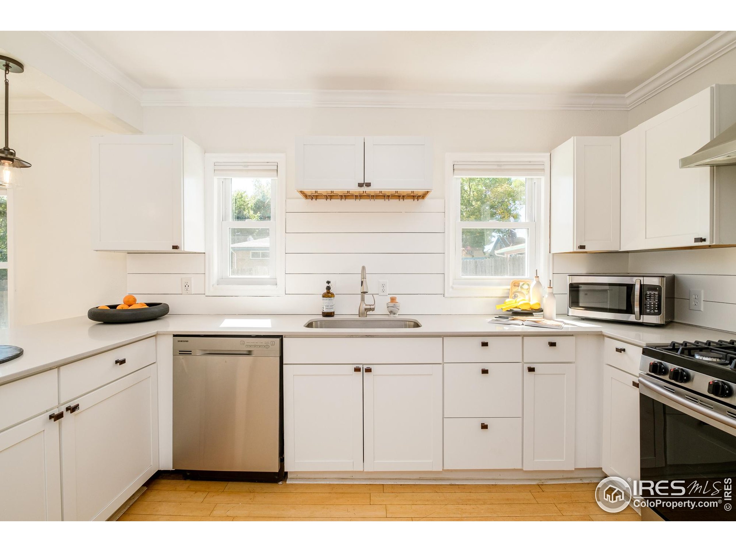 4635 Elm Court Denver, CO 80211 - Photo 9 of 30 a kitchen with granite countertop a sink cabinets stainless steel appliances and a window