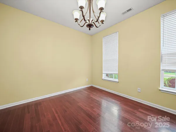 a view of a room with wooden floor and a window