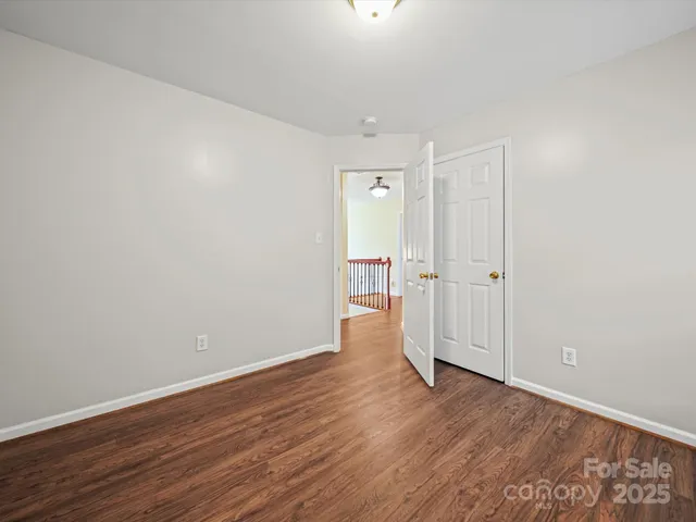 a view of a room with wooden floor