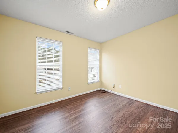 a view of a room with wooden floor and fan