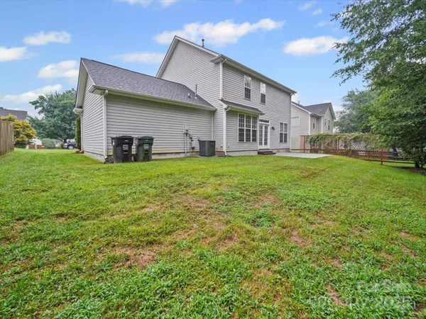 a view of a house with a backyard